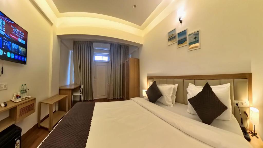 Postel nebo postele na pokoji v ubytování Maashpi Hotel & Resort, Candolim