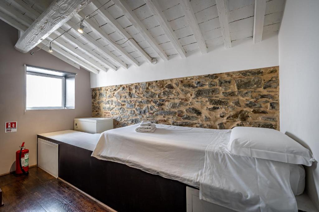 Posteľ alebo postele v izbe v ubytovaní Roommo Fortezza