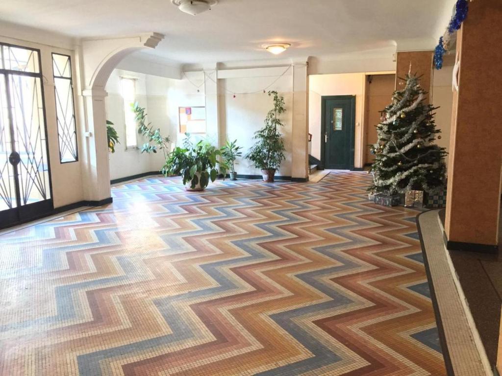 an empty lobby with a christmas tree on the floor at MONACO 3mn du casino in Beausoleil