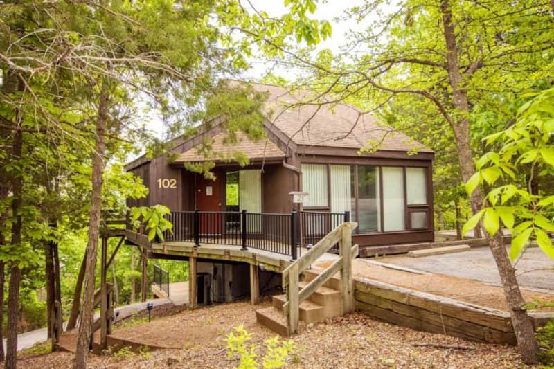 a house with a deck in the woods at Treetop Village-treetop Escape 102 in Four Seasons