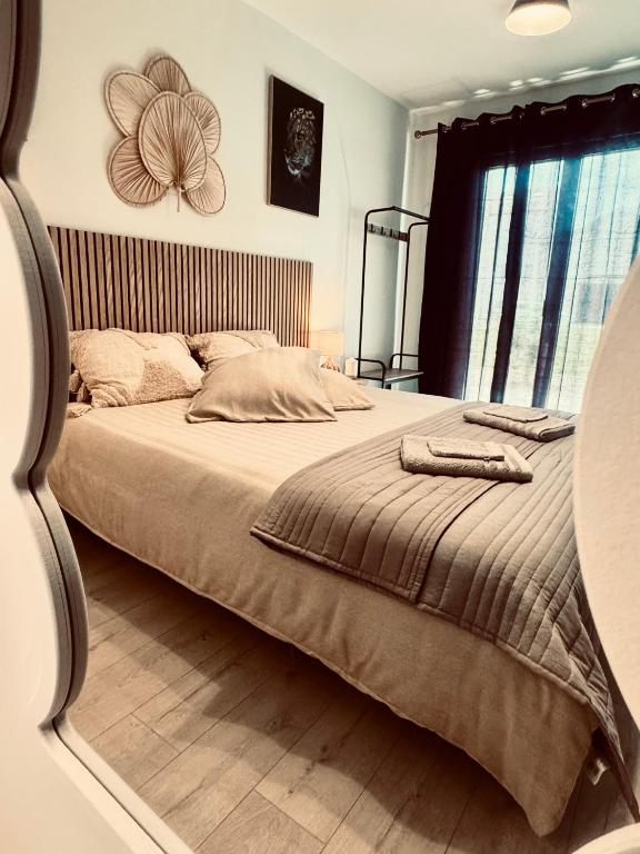 une chambre avec un grand lit avec un plancher en bois dans l'établissement Chambre d'hôte Centre Bergerac 4 places, à Bergerac