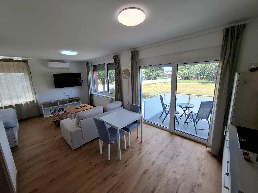 a living room with a couch and a table at 3 JABLANE apartmaji in Beltinci