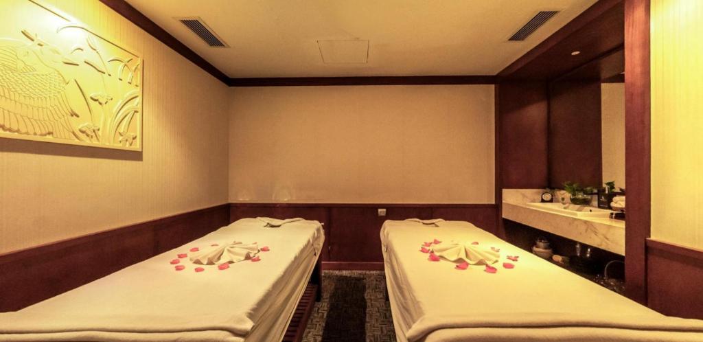 a room with two beds in a room at Boton Blue Hotel & Spa in Nha Trang