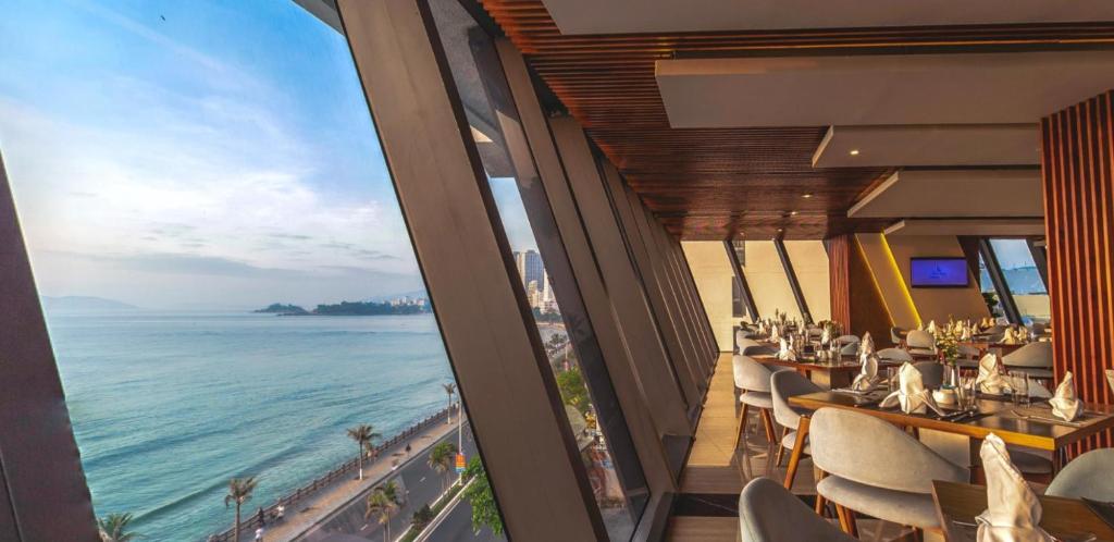 a restaurant with a view of the ocean at Boton Blue Hotel & Spa in Nha Trang
