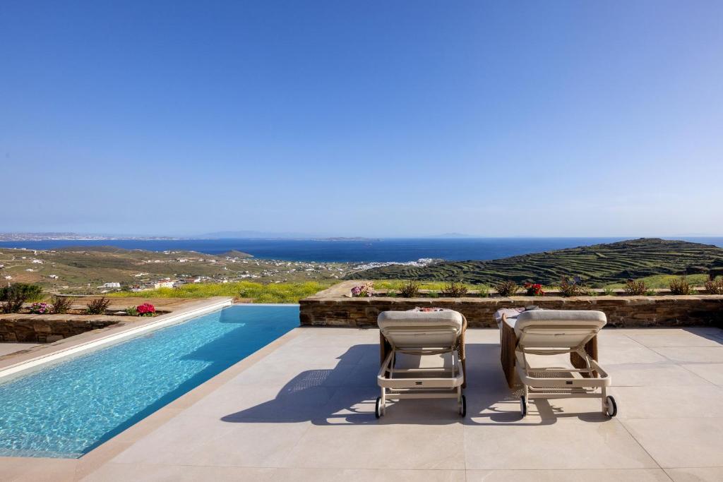 a villa with a pool and a view of the ocean at Soborgo Exquisite Villas in Tinos