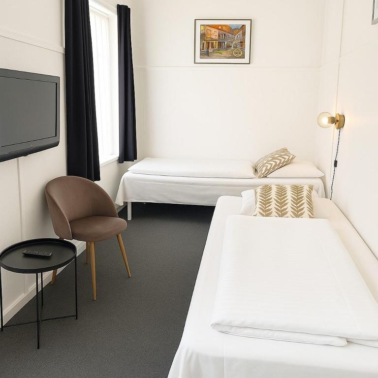 Postel nebo postele na pokoji v ubytování CentralHotellet