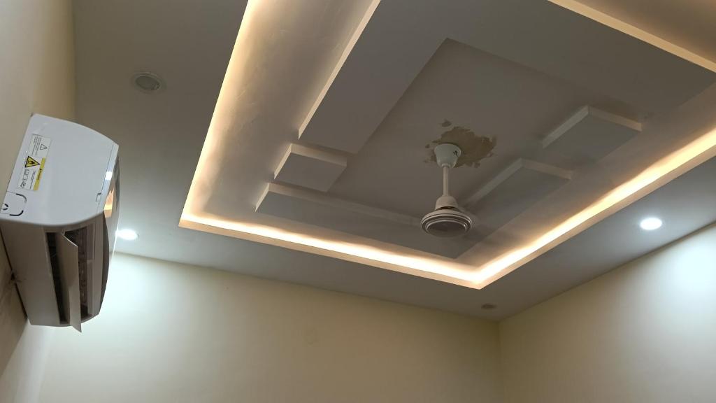 a ceiling with a light in a room at Govind Anand Dham in Vrindāvan
