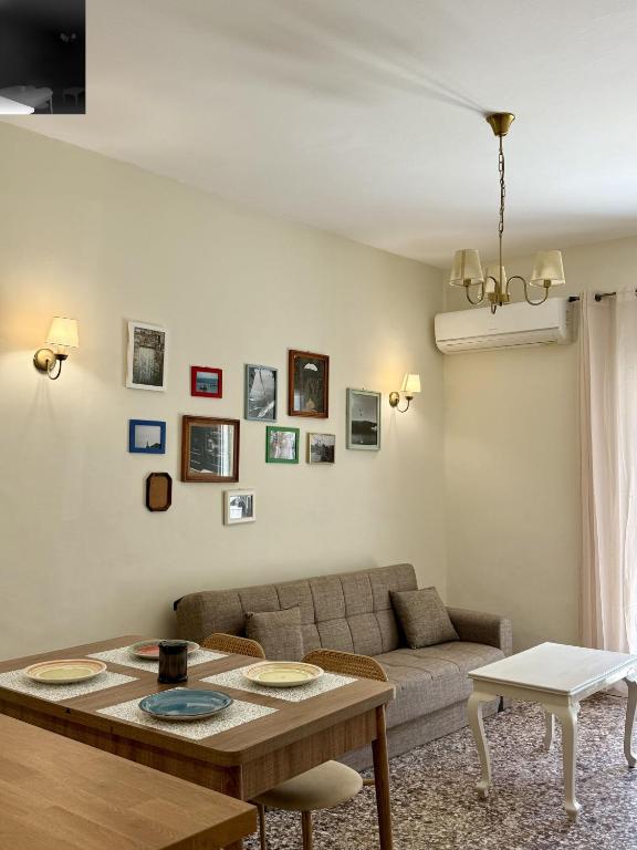 a living room with a couch and a table at Anefos apartment in Ágios Rókkos