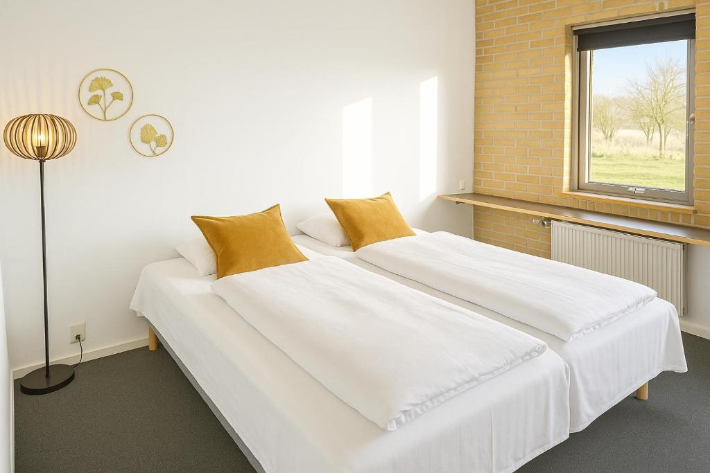 Postel nebo postele na pokoji v ubytování Hotel Svanegården