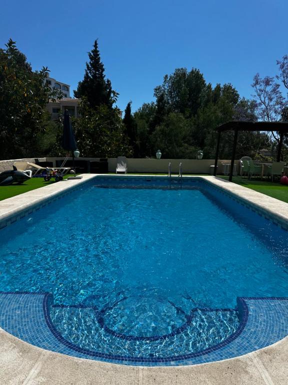 a large swimming pool with blue water at Villa Copacabana Family Loft in Jávea