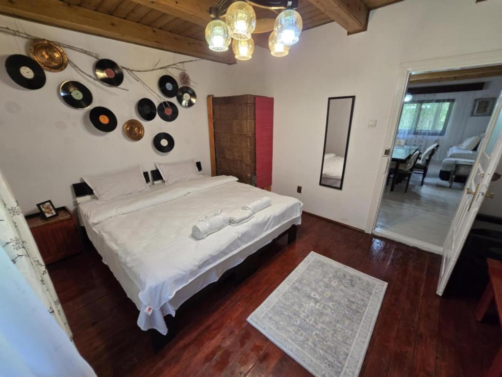 a bedroom with a large white bed and some pots and pans at Casa Daniela in Gura Humorului