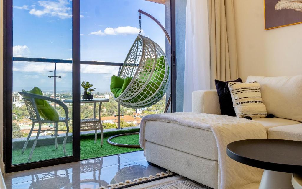 a living room with a couch and a large window at Panorama Suites in Nairobi with Swimmingpool,Wifi in Nairobi