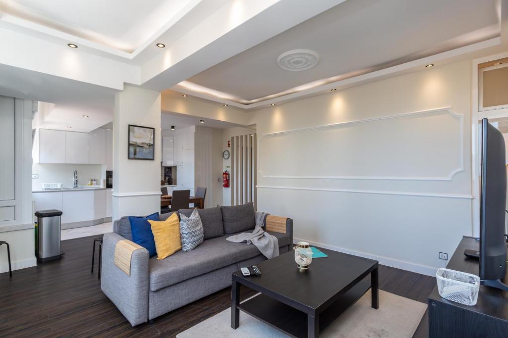 a living room with a couch and a table at BeGuest Casa dos Poetas Oeiras Apartment in Oeiras