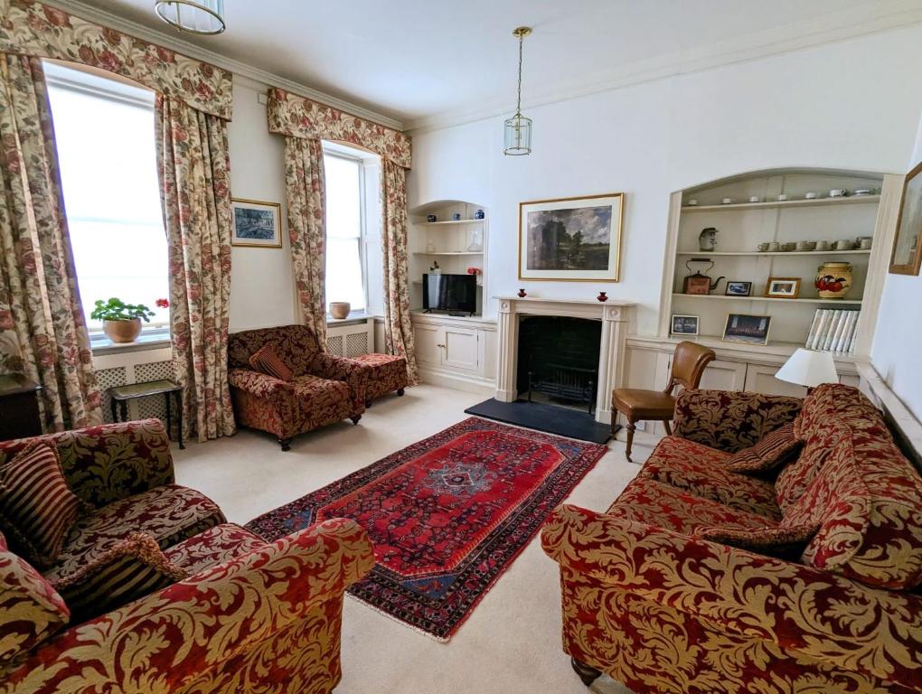 a living room with two couches and a fireplace at East Pallant Bed and Breakfast, Located in Large Georgian Townhouse in Central Chichester in Chichester