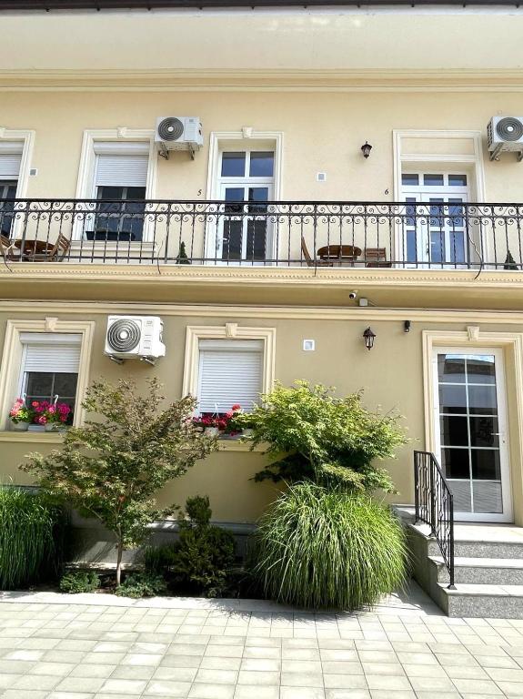 a building with a balcony on top of it at Princo Apartments in Hunedoara