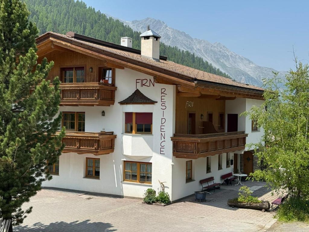 a building with wooden balconies on the side of it at Residence Firn in Solda