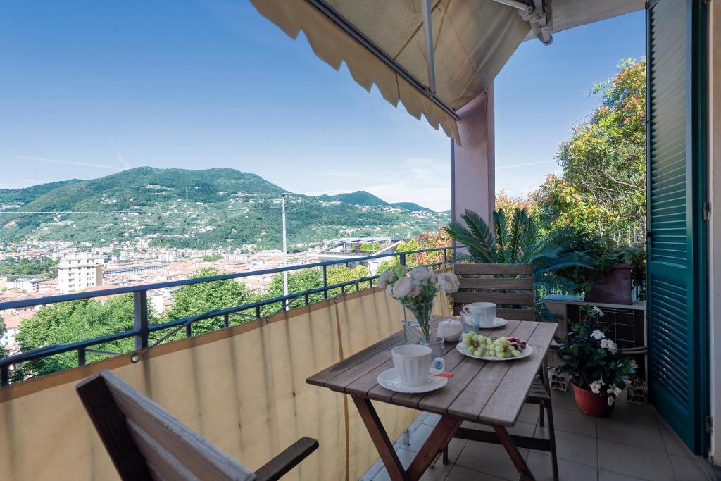 a table on a balcony with a view at ☆ Smart and relax flat ☆ TIZIANA' S HOLIDAY HOUSE - HOMY 5 TERRE in La Spezia