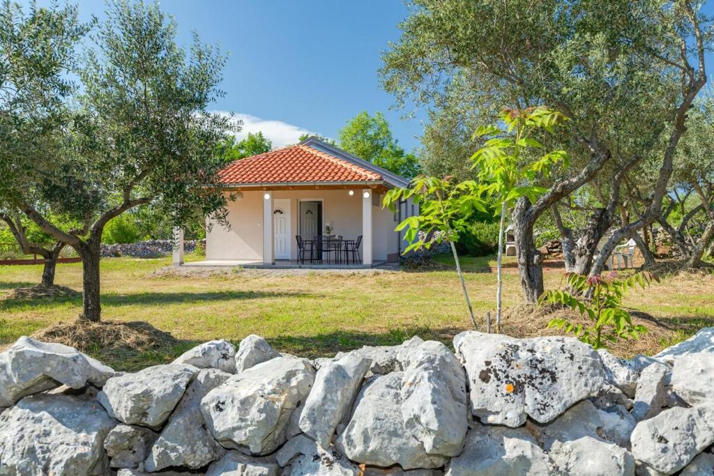 a stone fence in front of a house at Lara apartment for two in Skrbčići