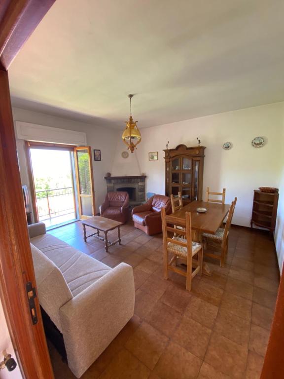 a living room with a couch and a table at Pasquina and the Val d'Orcia in Vivo dʼOrcia