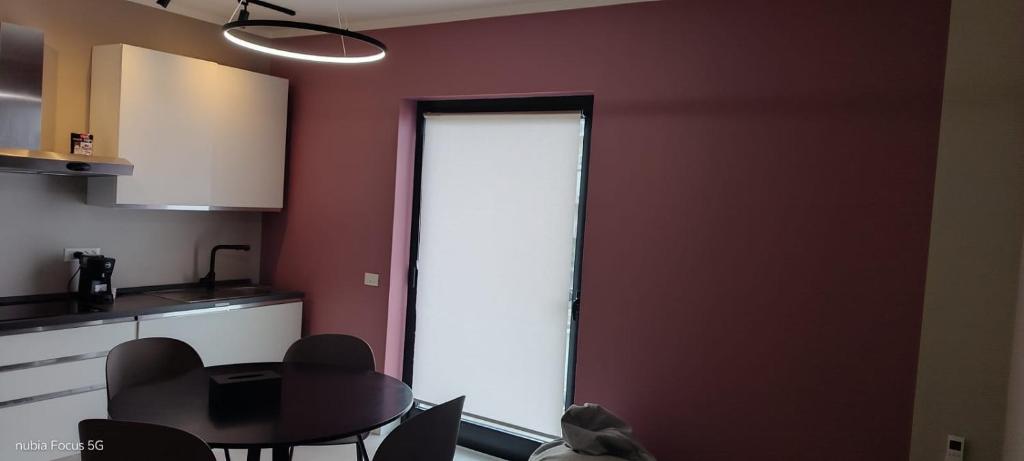 a room with a kitchen with a table and a door at La Panoramica in Varazze