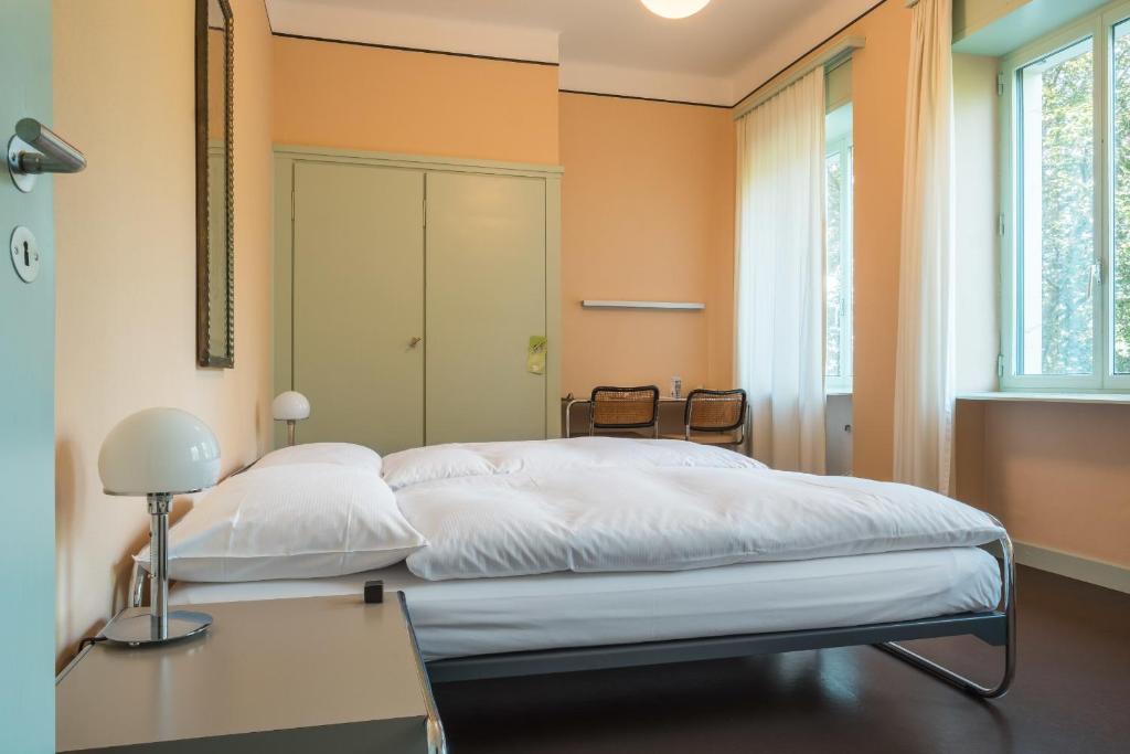 Una cama o camas en una habitación de Hotel Monte Verità