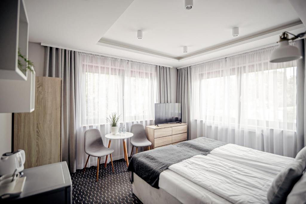 En eller flere senge i et værelse på Dom Gościnny Dana