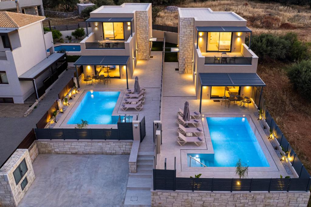 an aerial view of a house with a swimming pool at Petrus Luxury Villas in Old Hersonissos - 3 Bedrooms & 3 Bathrooms in Hersonissos