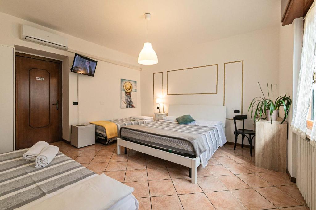 Postel nebo postele na pokoji v ubytování InGarda Rooms
