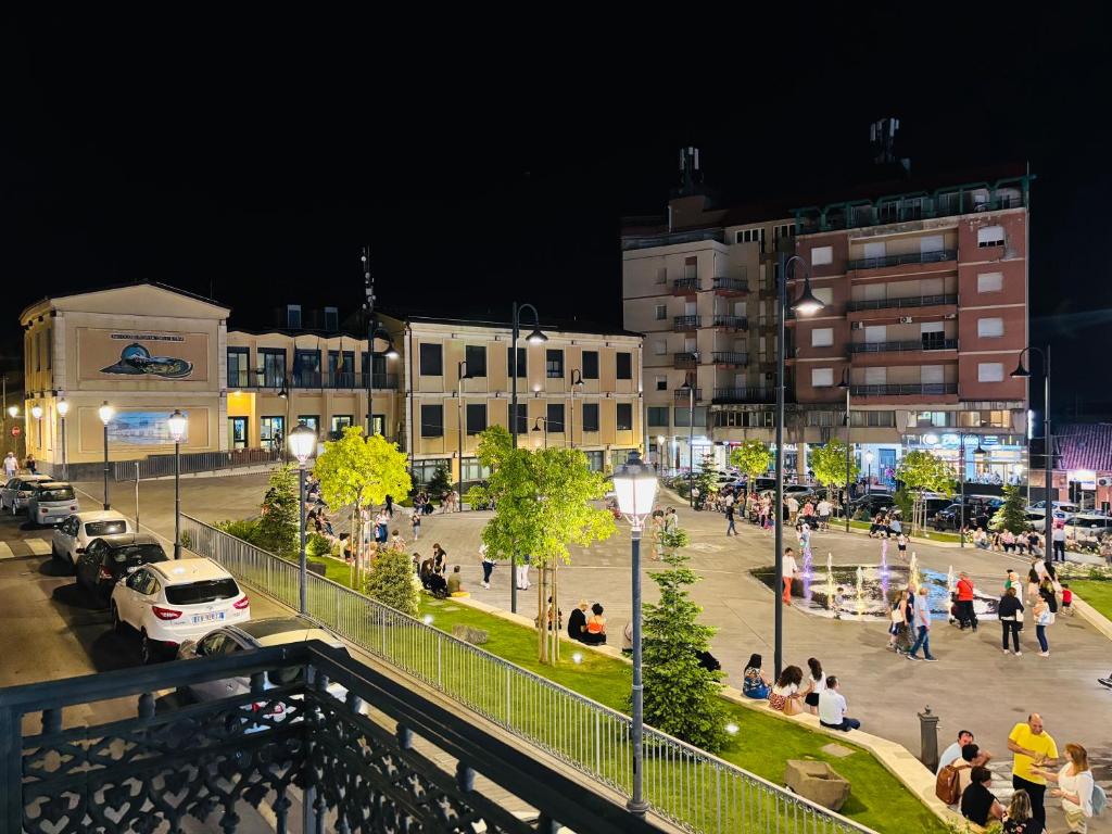 a group of people walking around a city at night at La Dama dell'Etna in Nicolosi