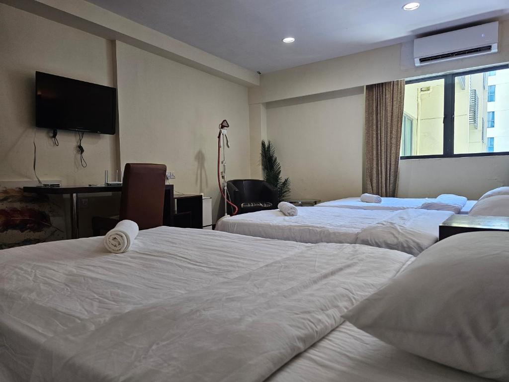 Postel nebo postele na pokoji v ubytování Kota Kinabalu City Ensuite at SCSP Ming Garden