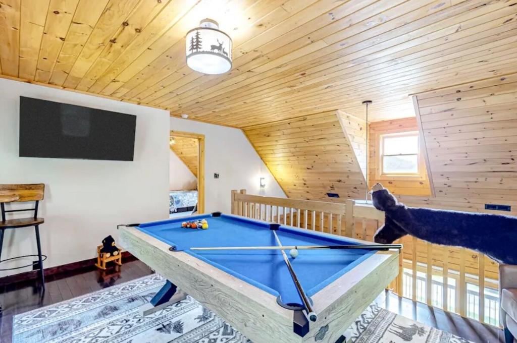 a pool table in the middle of a room at Grandpa John Cabin - Hot Tub, Game Room in Sugar Grove