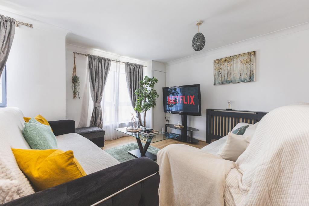 a living room with two couches and a tv at Spacious Wembley Flat Comfy Beds 2 Baths in London