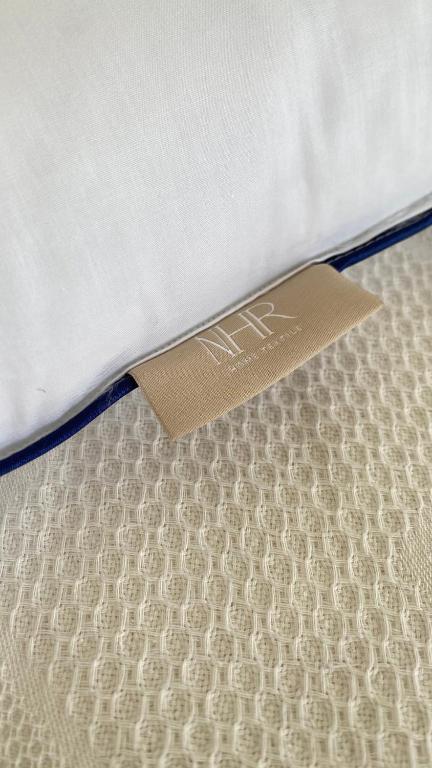 a mattress with a tag on top of it at AkdenizVillas in Kaş