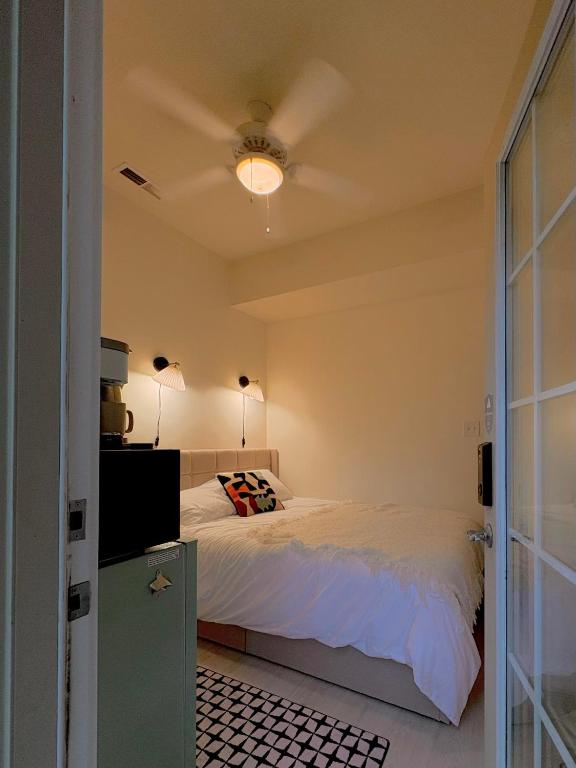 a bedroom with a bed and a ceiling fan at Sattva Home in Charlottesville