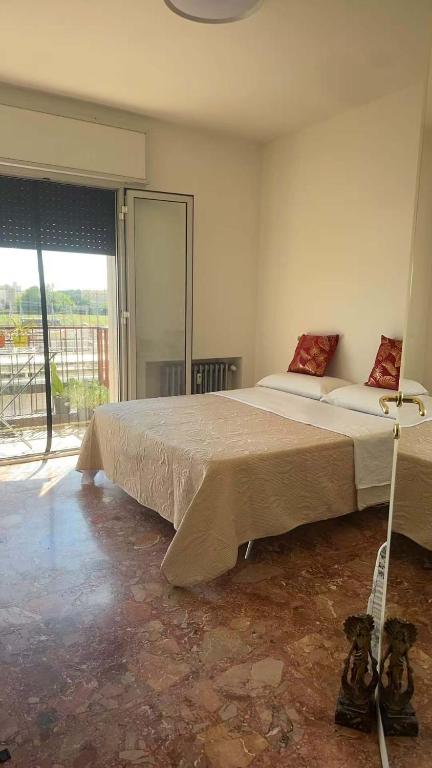 a bedroom with a large bed and a large window at stazione Lina house in Venice