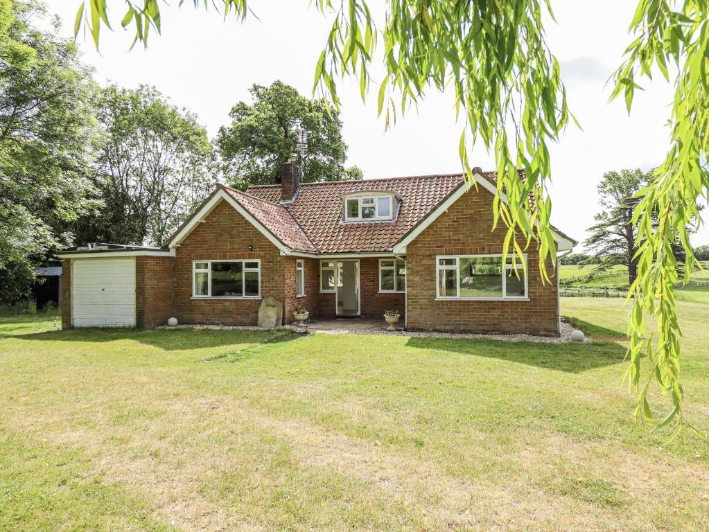 a brick house with a yard at Lake View Cottage in Alford