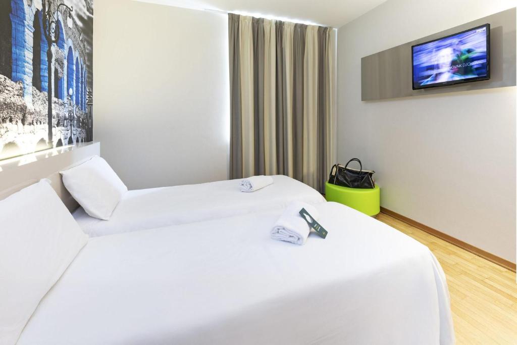 Postel nebo postele na pokoji v ubytování B&B Hotel Verona