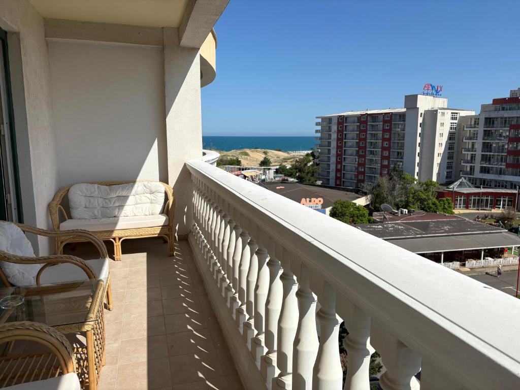 a balcony with a chair and a view of a city at Miramar palace 615S in Sunny Beach
