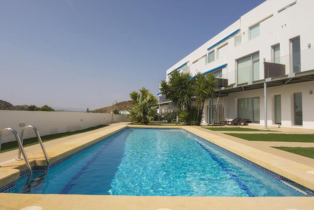 a swimming pool in front of a building at Fantástica Casa Adosada con Piscina y Parking in Mojácar