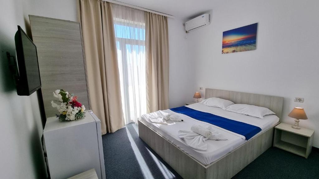 Postel nebo postele na pokoji v ubytování Neptun Resort
