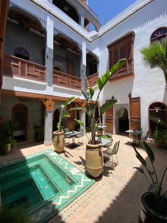 a courtyard with a swimming pool in a house at Riad Bab Yacout in Marrakech