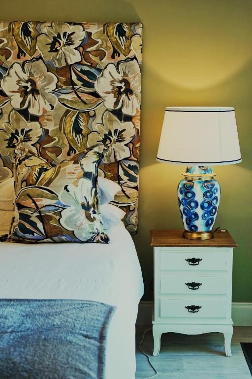 a bedroom with a bed with a lamp on a night stand at 182 Old Transkei Road in East London