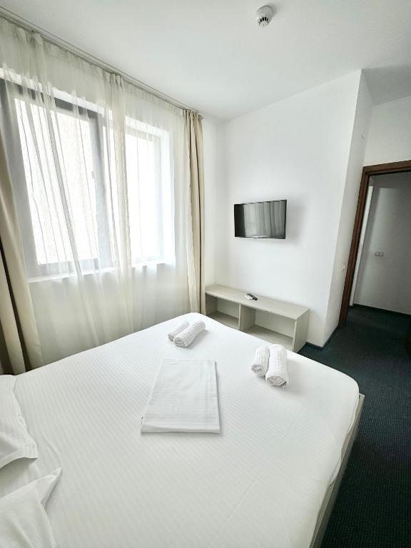 Postel nebo postele na pokoji v ubytování Neptun Resort