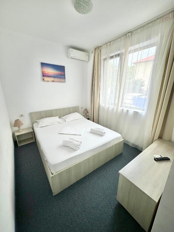 Postel nebo postele na pokoji v ubytování Neptun Resort