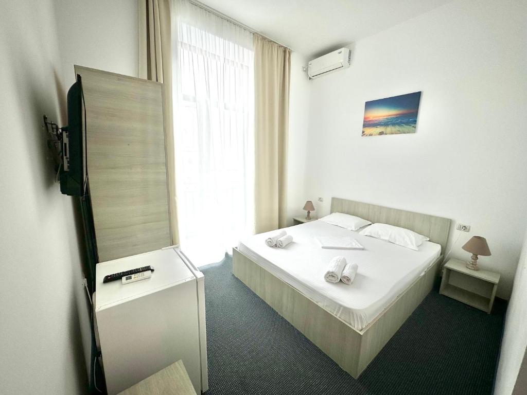 Postel nebo postele na pokoji v ubytování Neptun Resort