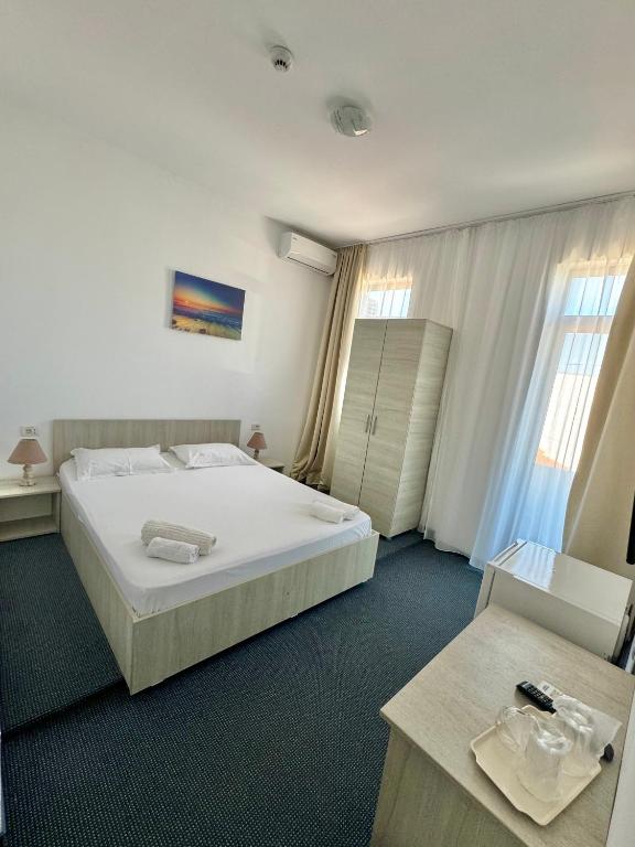 Postel nebo postele na pokoji v ubytování Neptun Resort