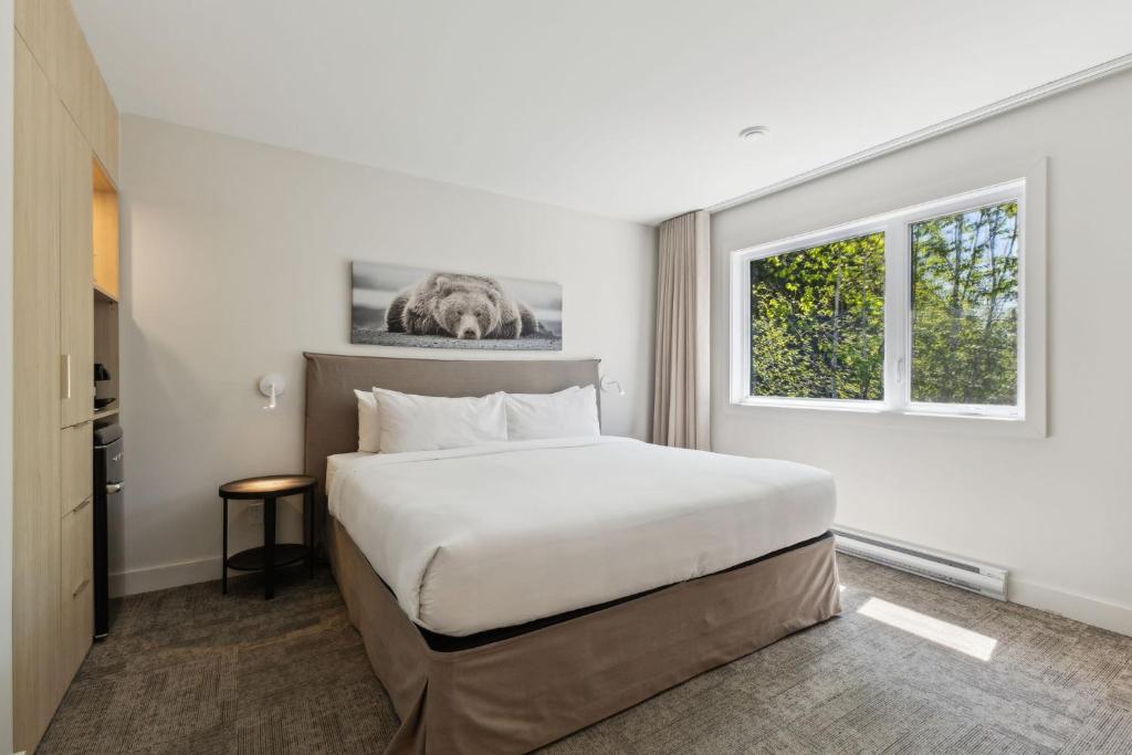Postel nebo postele na pokoji v ubytování Suites du Lac Moore