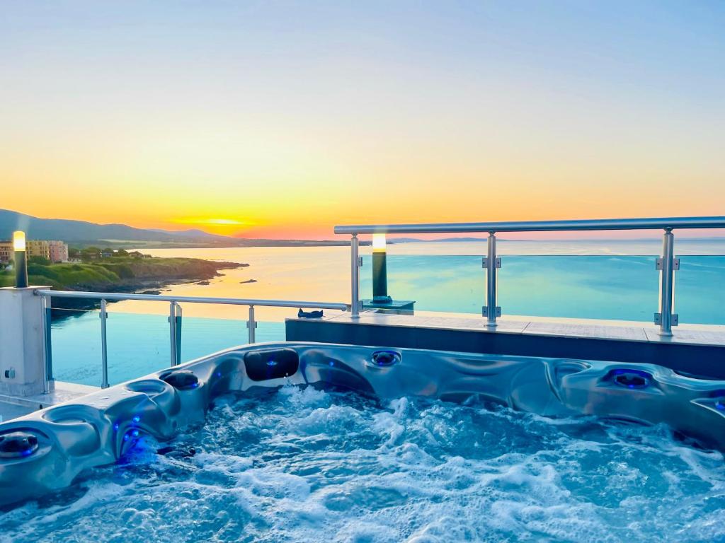 a hot tub on the deck of a cruise ship with the sunset at AGATA BEACH Boutique -Adult Only in Ahtopol