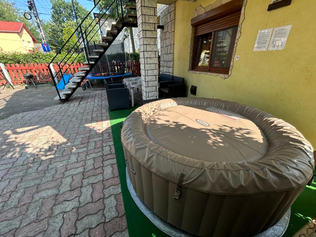 a large trash can sitting outside of a building at Edu Apartman in Hajdúszoboszló