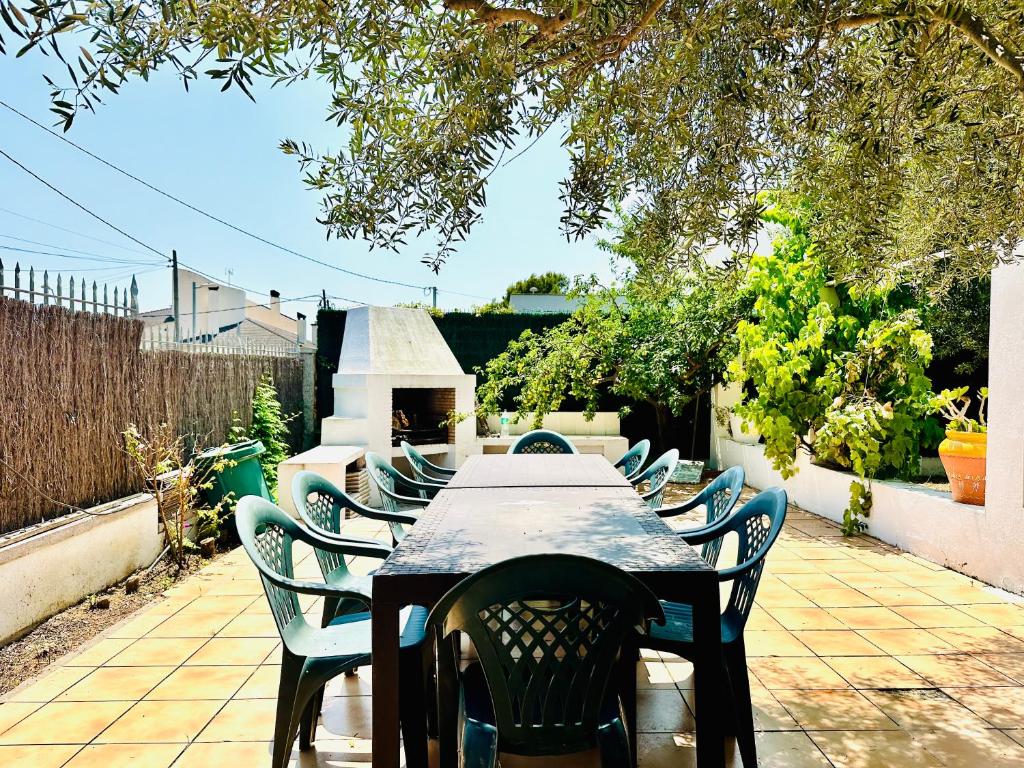a wooden table with chairs and a table and a table and chairs at Global Immo 8010 Montclar in Roses